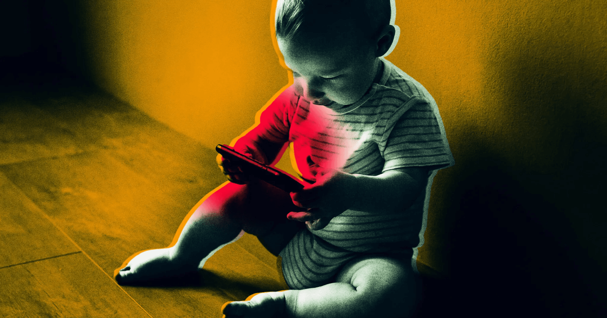 A child lit by a phone screen.